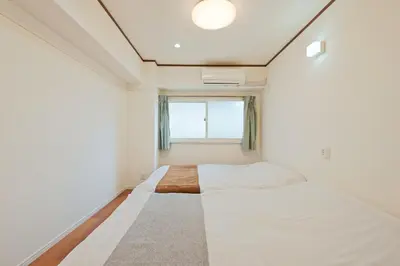 a small bedroom with a bed and a window at V Close to Shinjuku Kabukicho Korean Town FrWIFI J in Tokyo