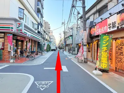 an empty city street with a red arrow on the road at \u98a8\u82b1Fuka\u6c11\u6cca\u5927\u68ee\u897f002 in Tokyo