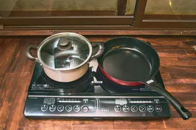 a pot on top of a stove with a pan on it at \u548c\u6c23\u4f1a\u3005\u66f3\u821f Wakiaiai Hikihune in Tokyo
