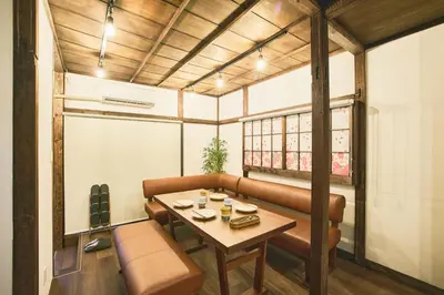 a room with a table and a couch and a table and a window at \u548c\u6c23\u4f1a\u3005\u66f3\u821f Wakiaiai Hikihune in Tokyo