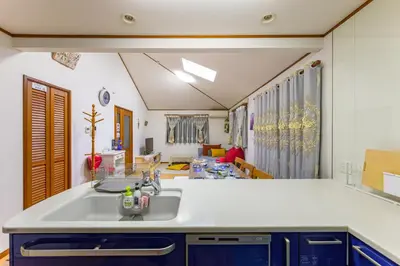 a kitchen with a sink and a living room at Nakano Shinjuku Sapphire Single-family House in Tokyo