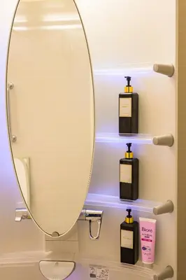 a bathroom with a mirror and some soap dispensers at Nakano Shinjuku Sapphire Single-family House in Tokyo