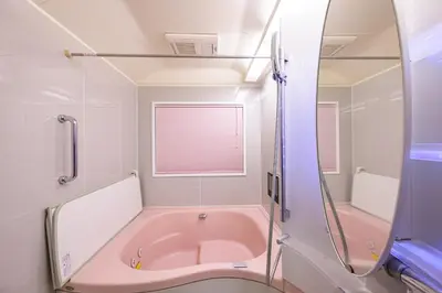 a pink bath tub in a bathroom with a window at Nakano Shinjuku Sapphire Single-family House in Tokyo