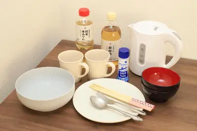 a table with plates and utensils on a table at UT Apart Ikebukuro \u6c60\u888b\u99c5\u5f92\u6b6910\u5206 in Tokyo