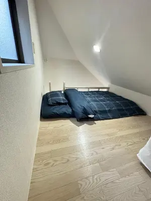 a small bedroom with a bed in the attic at UT Apart Ikebukuro \u6c60\u888b\u99c5\u5f92\u6b6910\u5206 in Tokyo