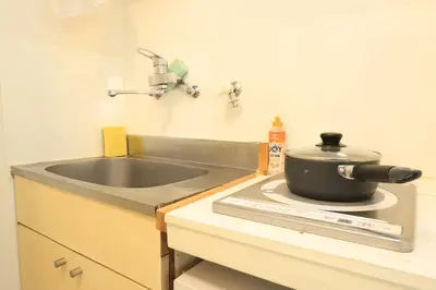 a kitchen with a sink and a pot on a stove at UT Apart Ikebukuro \u6c60\u888b\u99c5\u5f92\u6b6910\u5206 in Tokyo