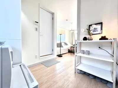 a living room with a large mirror and a white room at shinjuku yichun hostel-SJ0399 in Tokyo