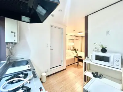 a kitchen with a stove and a microwave at shinjuku yichun hostel-SJ0399 in Tokyo