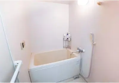 a white bath tub in a bathroom with a sink at 9th floor Elevator Yamanote Line Komagome Station 3 mins walk 3 rooms 1 room 1 room Direct access to Shinjuku Ueno Akihabara Ginza Tokyo Ikebukuro Shinjuku Shibu in Tokyo