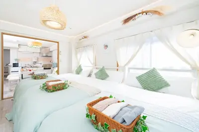 two beds in a bedroom with a wicker basket at Stay in the most popular city for young people in Japan in Tokyo