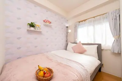 a bedroom with a bed with a basket of fruit on it at Stay in the most popular city for young people in Japan in Tokyo