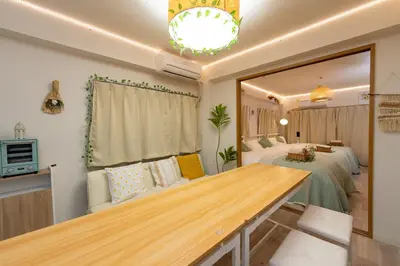 a room with two beds and a table in it at Stay in the most popular city for young people in Japan in Tokyo