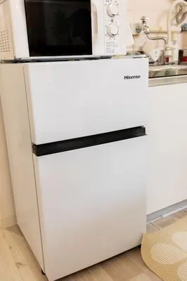 a white refrigerator with a microwave on top of it at Stay in the most popular city for young people in Japan in Tokyo