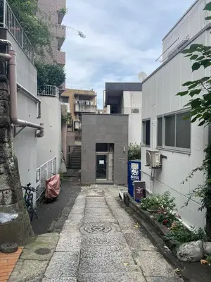 an alley in a city with a building at Shinjuku Yotsuya Sanchome Station 7-minute walk Hawaiian Twin Bed Charm Room 1R in Tokyo