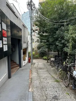 an empty alley with bikes parked next to a building at Shinjuku Yotsuya Sanchome Station 7-minute walk Hawaiian Twin Bed Charm Room 1R in Tokyo