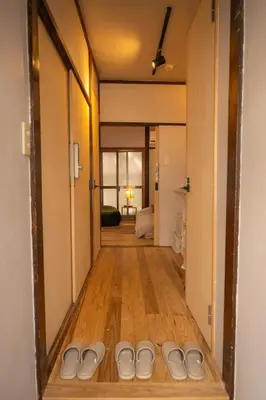 a hallway with a row of white shoes on the floor at Roopt\u795e\u697d\u5742 in Tokyo