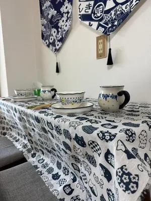 a table with blue and white plates and bowls on it at \u4e0a\u91ce\u5708\u5f92\u6b65\u516c\u5bd3\u578b\u9152\u5e97 \u4e0b\u8c37\u99c5\u304b\u3089\u5f92\u6b653\u5206 in Tokyo