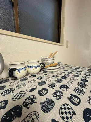 a table with two tea cups on a patterned table cloth at \u4e0a\u91ce\u5708\u5f92\u6b65\u516c\u5bd3\u578b\u9152\u5e97 \u4e0b\u8c37\u99c5\u304b\u3089\u5f92\u6b653\u5206 in Tokyo