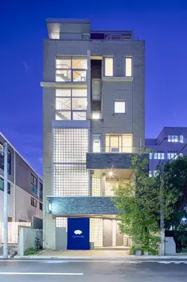 a tall building with a blue door in front of it at Kyo-wa Hotel in Tokyo