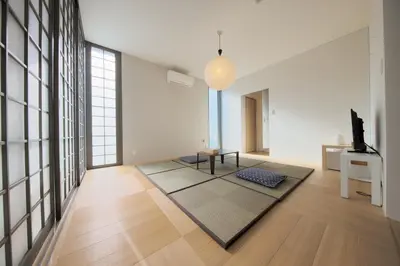 a living room with a table and a rug at Kyo-wa Hotel in Tokyo