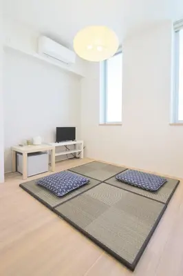 a living room with two meditation mats on the floor at Kyo-wa Hotel in Tokyo
