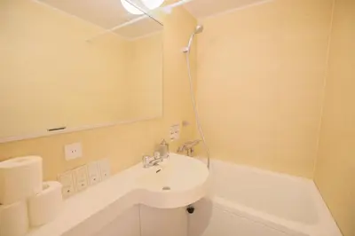 a white bathroom with a sink and a bath tub at Kyo-wa Hotel in Tokyo