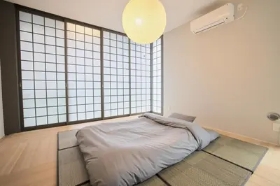 a bed in a room with a large window at Kyo-wa Hotel in Tokyo