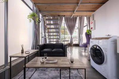 a living room with a washing machine and a couch at Natsumezaka Room1 NM1 in Tokyo