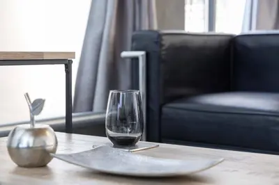 a glass of wine sitting on a table next to a chair at Natsumezaka Room1 NM1 in Tokyo