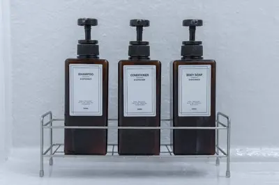 three bottles ofodorizers sitting on a metal rack at Natsumezaka Room1 NM1 in Tokyo