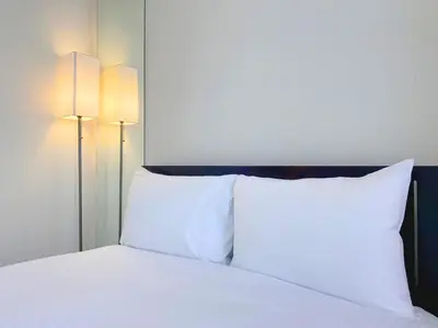 a bed with two white pillows and two lights at Pangoo Shinagawa Room 101 - Vacation STAY 93916v in Tokyo