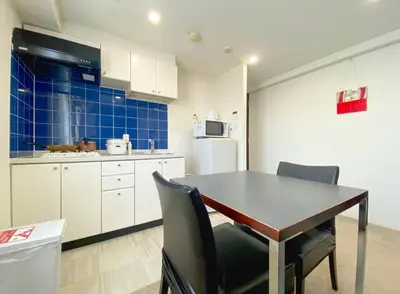 a kitchen with a table and chairs in a room at Pangoo Shinagawa Room 101 - Vacation STAY 93916v in Tokyo