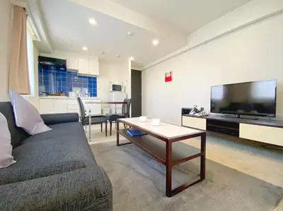 a living room with a couch and a table at Pangoo Shinagawa Room 101 - Vacation STAY 93916v in Tokyo