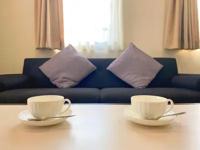 two cups on a table in a living room with a couch at Pangoo Shinagawa Room 101 - Vacation STAY 93916v in Tokyo