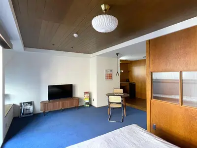 a room with a bed and a tv and a table at NO SERVICE HOTEL asakusa in Tokyo