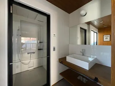 a bathroom with a white sink and a mirror at NO SERVICE HOTEL asakusa in Tokyo