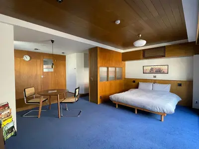 a bedroom with a bed and a table and chairs at NO SERVICE HOTEL asakusa in Tokyo