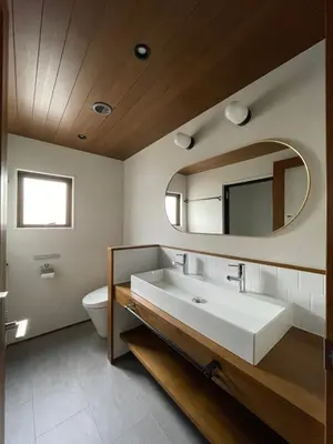 a bathroom with a white sink and a mirror at NO SERVICE HOTEL asakusa in Tokyo