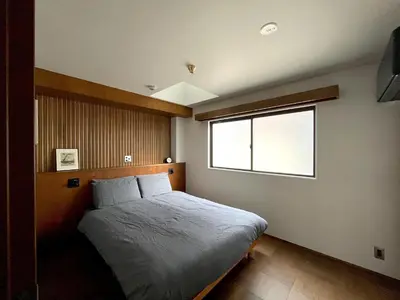 a bedroom with a bed and a window at NO SERVICE HOTEL asakusa in Tokyo