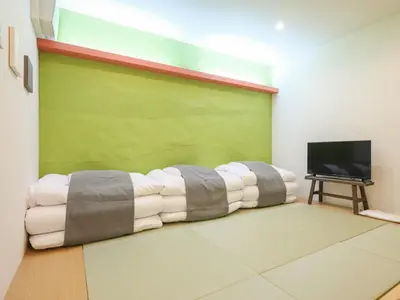 a room with a bed in front of a television at HOTEL \u5fc3 asakusa in Tokyo