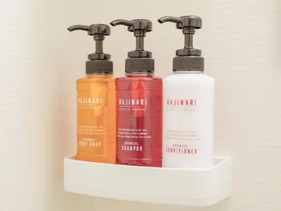 a shelf with three bottles of liquids on it at HOTEL \u5fc3 asakusa in Tokyo