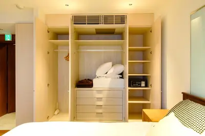 a bedroom with a built in closet with a bed at Roppongi House by U - Designers room - Steps to Roppongi Hills & Nightlife in Tokyo