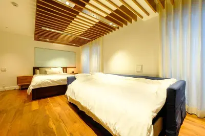 a bedroom with two beds and a large window at Roppongi House by U - Designers room - Steps to Roppongi Hills & Nightlife in Tokyo