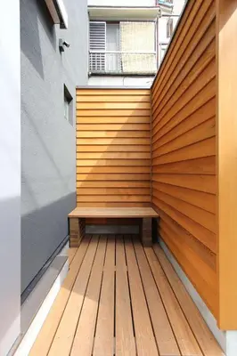 a wooden retaining wall with a bench on a deck at Tokyo Villa Kameido in Tokyo