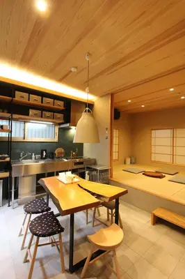 a kitchen with a wooden table and some chairs at Tokyo Villa Kameido in Tokyo