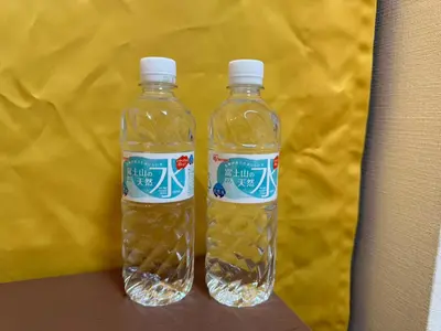 two bottles of water sitting on top of a table at YIYou Japan\u79cb\u8449\u539f301 in Tokyo