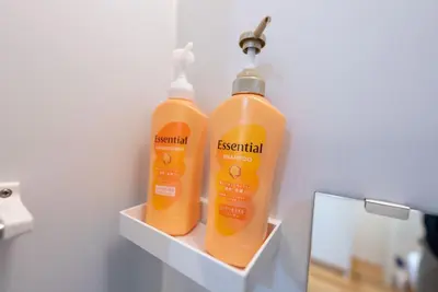 two bottles of orange shampoo sitting on a shelf at YIYou Japan\u79cb\u8449\u539f301 in Tokyo