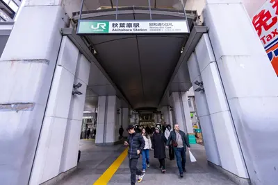 a group of people walking through a building at YIYou Japan\u79cb\u8449\u539f301 in Tokyo