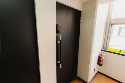 a black door in a room with a window at Guesthouse Akasaka in Tokyo