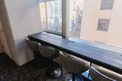 a table and chairs in a room with a window at Guesthouse Akasaka in Tokyo